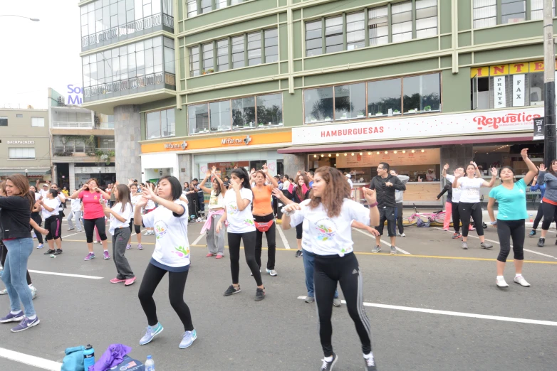 the group of women is playing with each other in the street