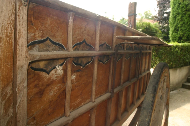 a gated metal and wood design made out of various boards