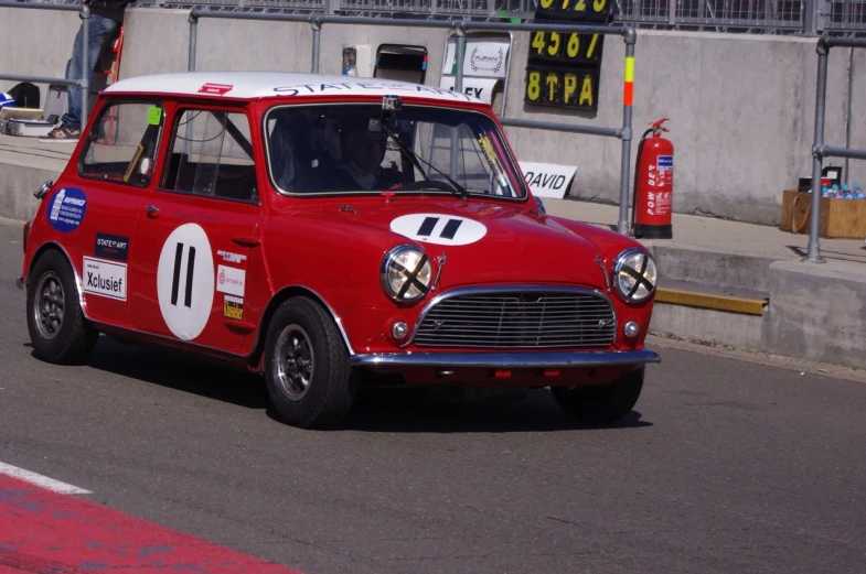 a small red race car driving on a track