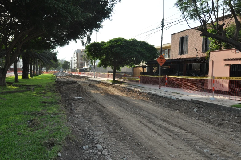 there is a dirt road with two buildings