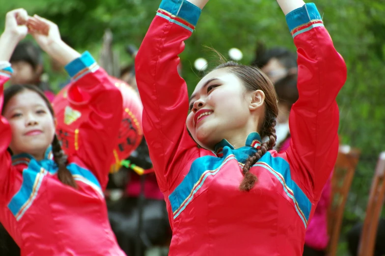  in red performing chinese dance moves