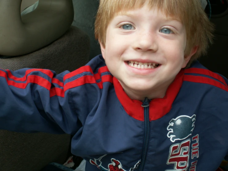 a small child sitting in the back seat of a car