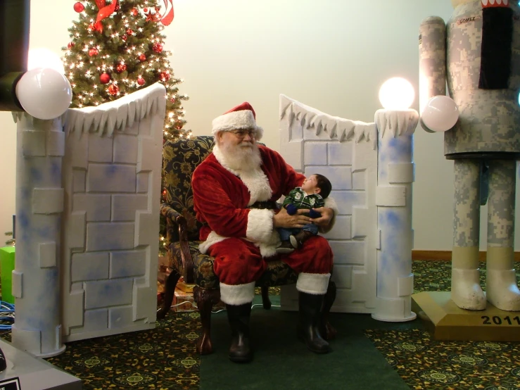 a santa clause in a christmas suite with his child