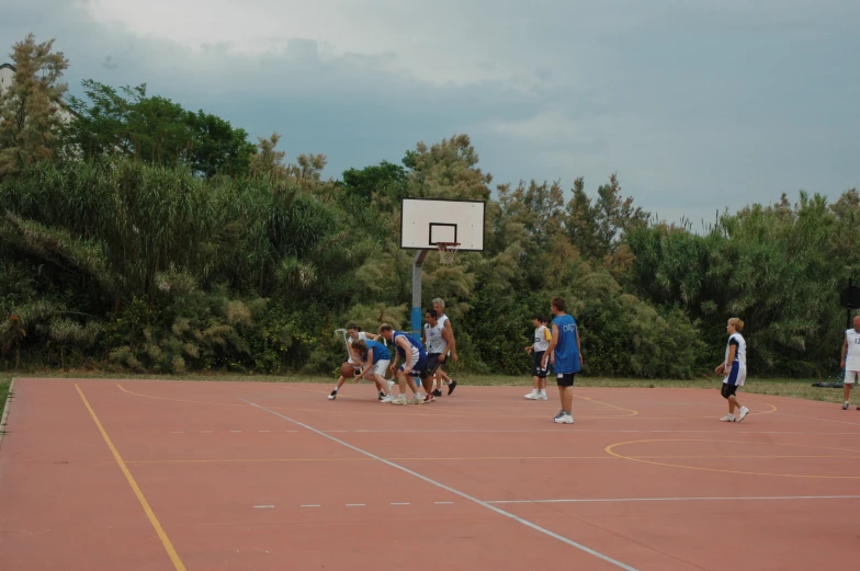 a group of people standing on top of a basketball court