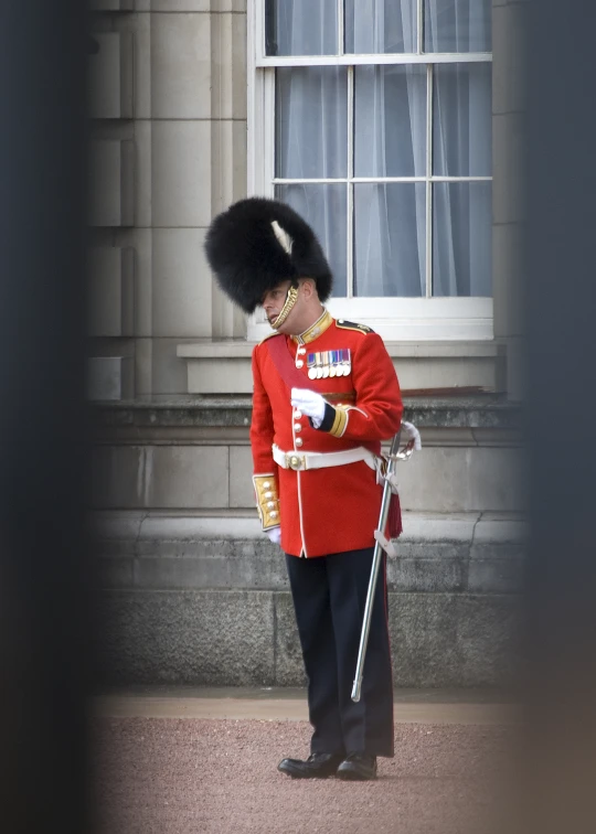 a guard dressed in an uniform and holding a sword