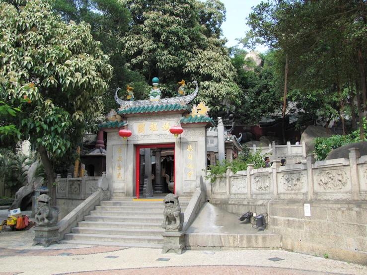 an ancient chinese temple sits in the center of a park