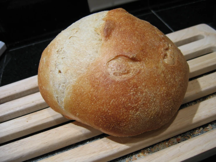 a freshly baked loaf of bread sitting on top of a wooden table