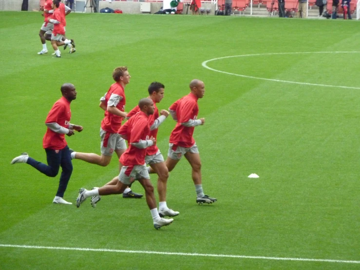a group of men in red shirts playing a game
