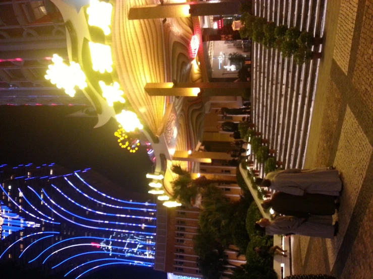 a large building at night with lit up lights and lights behind it