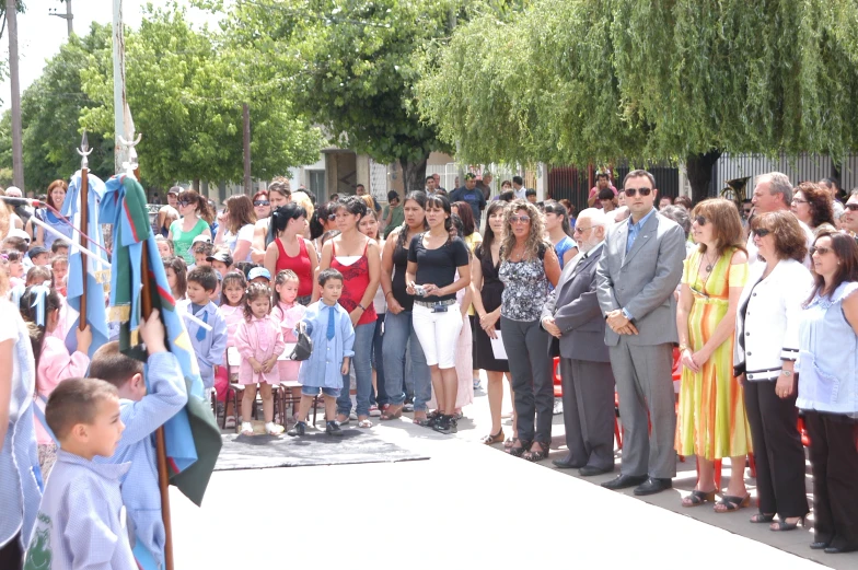 a group of people stand in front of a crowd and watch