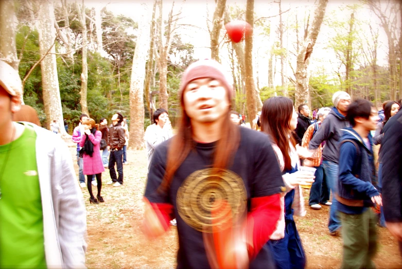 a man holding onto a disc with other people in the background