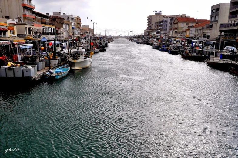 a river flowing through a city next to tall buildings