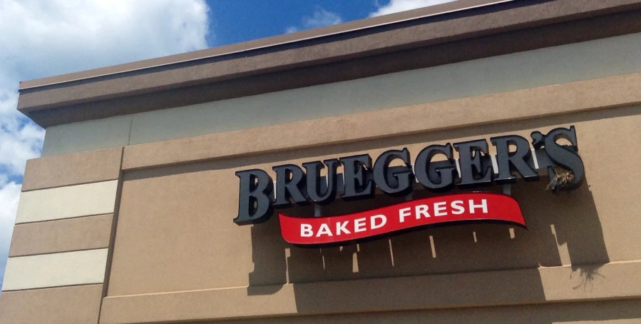 the front of a bakery with large black letters and red banner