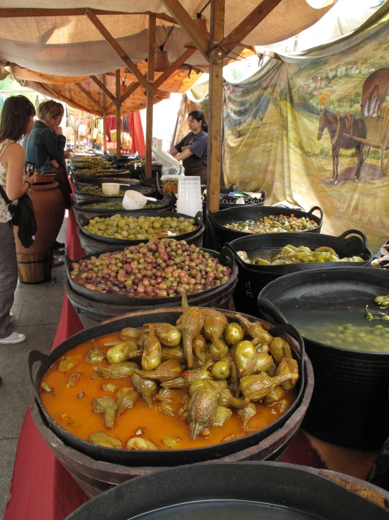 food stands full of dishes for sale in a rural market