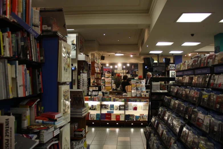 a bookstore with numerous bookshelves and people shopping