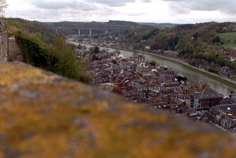 a river and old buildings next to some hills