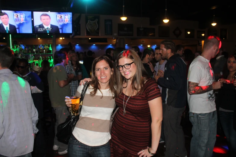 two women smile as they pose for the camera