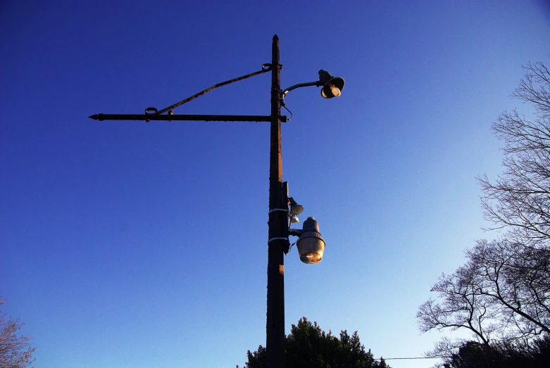 the light poles with street lights in their lights are lit up at night