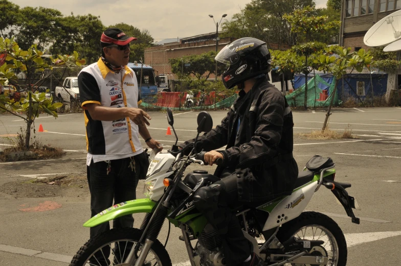 a man with a helmet sitting on a motorcycle