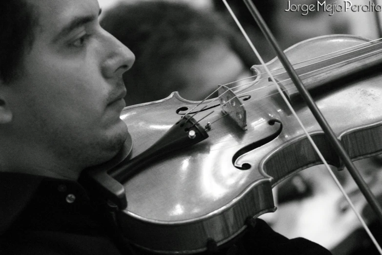 a close up of a violin with a person in the background