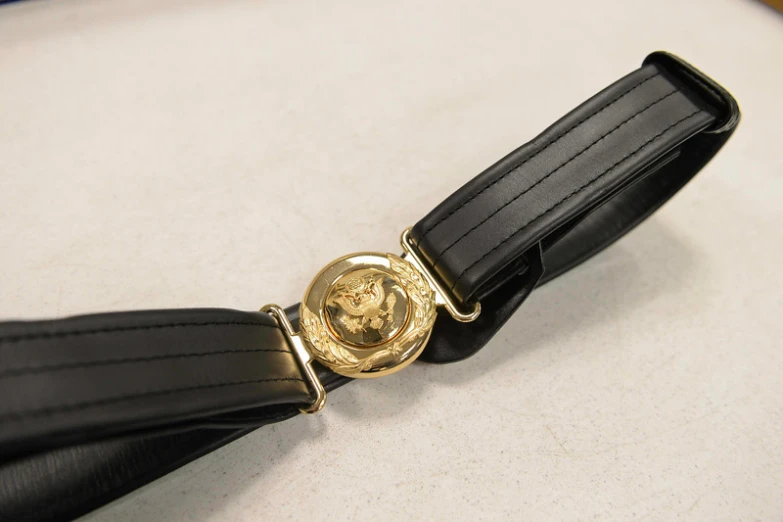 a gold plated watch and black leather strap