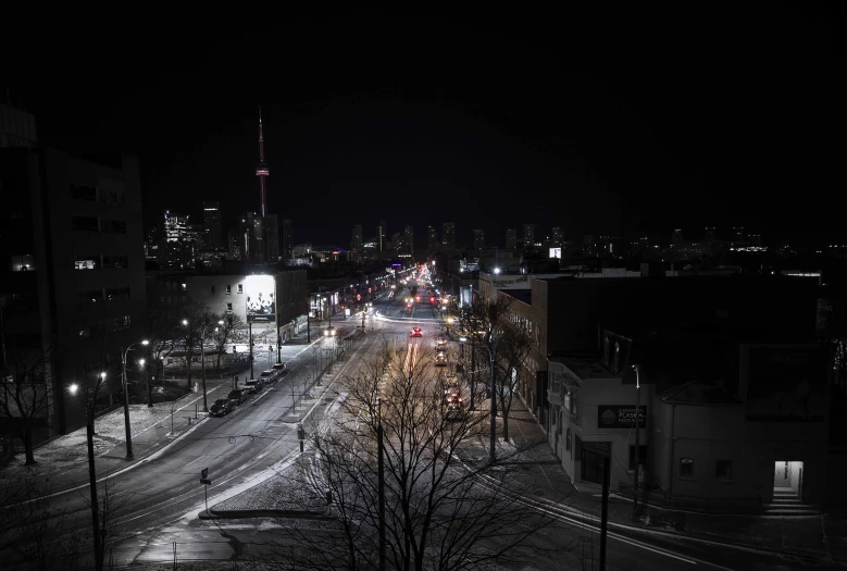 street lights lit up on an empty downtown street