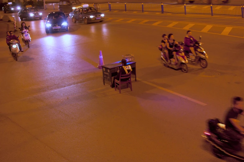 people riding motorcycles on a street at night