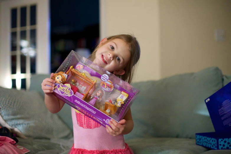  holding the box she has packed for a doll house project