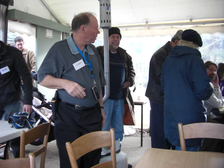 a man that is standing under a tent