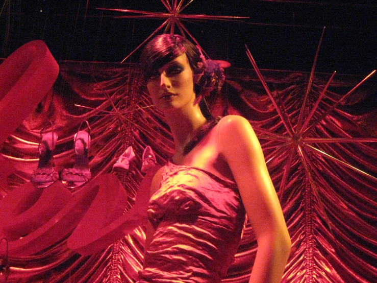 a woman walking on a runway wearing a purple dress