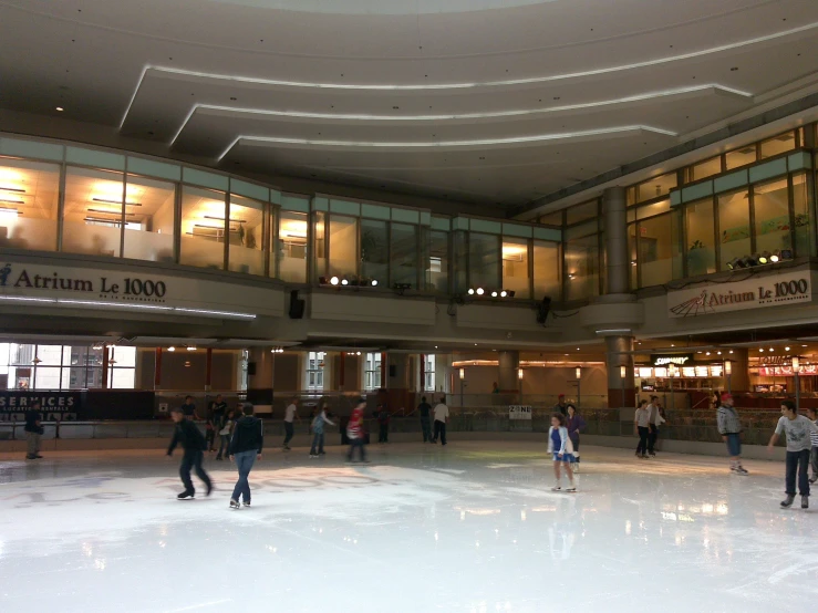 a group of people skating in a large room