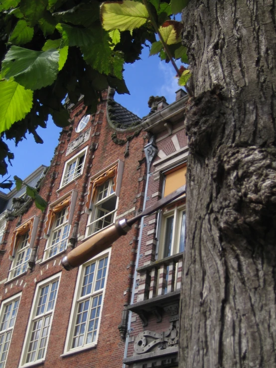 an ornate red brick building is shown from below