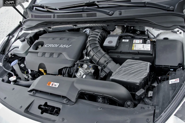 the engine of a car parked on a concrete surface