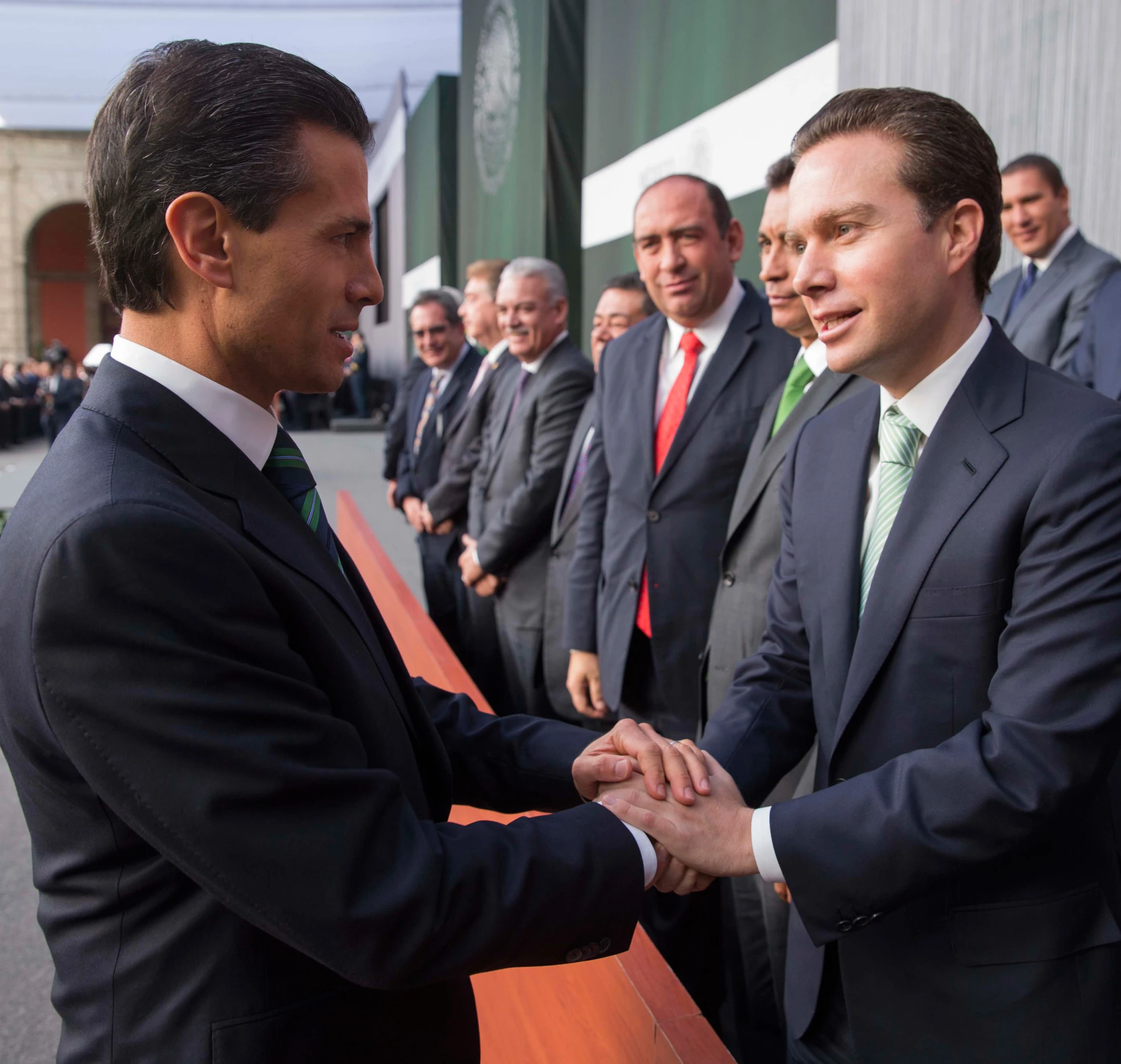 a group of men in suits shaking hands