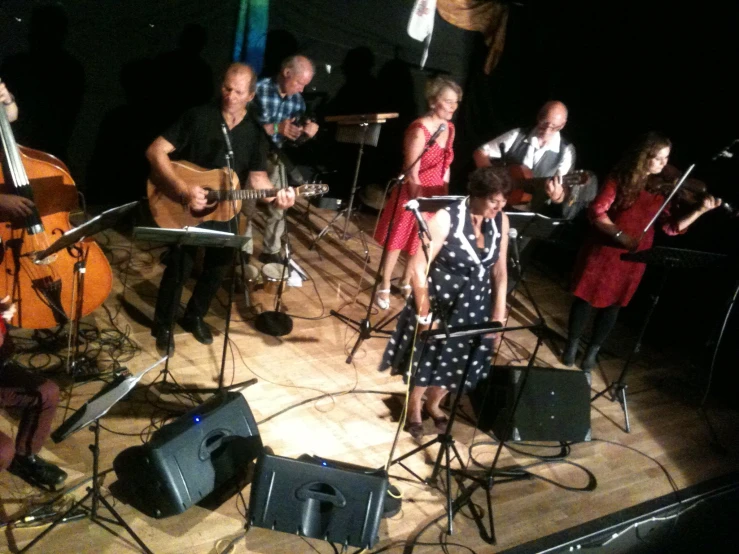 a woman sitting on a stage with musical instruments