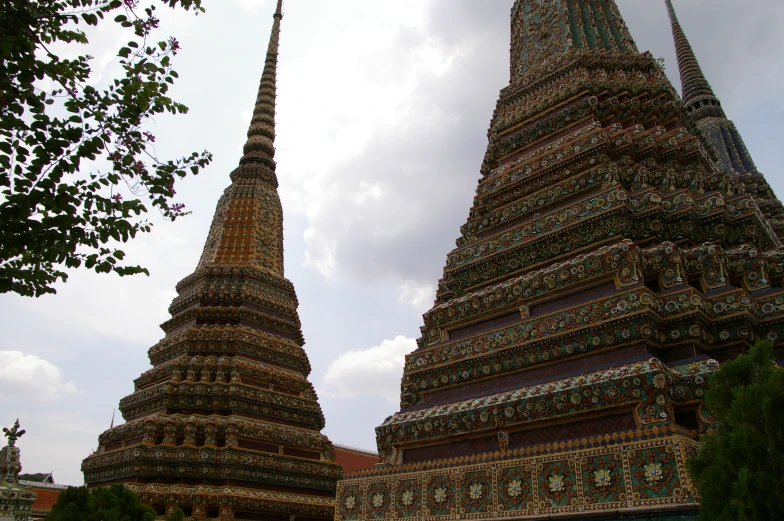 two tall pagodas stand tall in a park