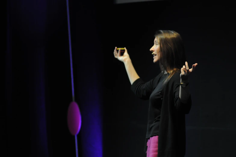 a woman is standing with her hands in the air