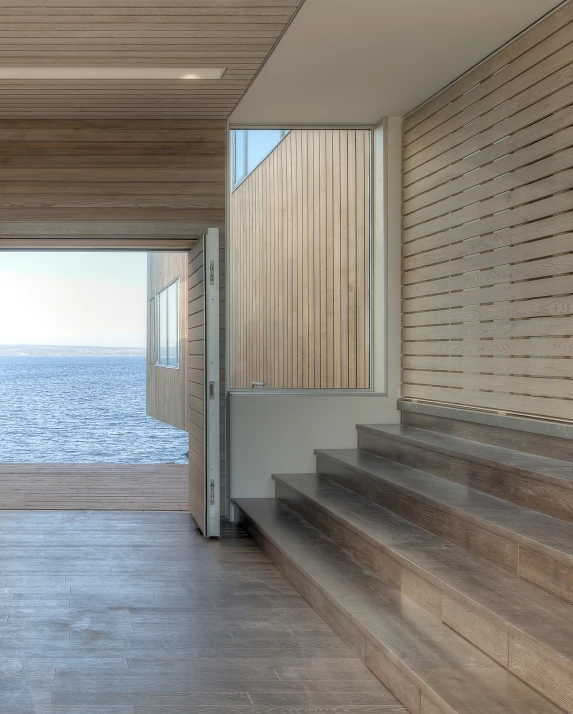 an entryway to the ocean from a staircase leading up to a house