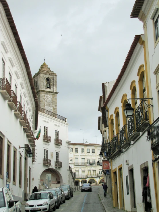 an older european style city street with a clock tower