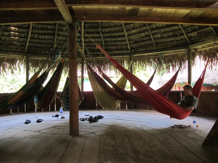 a woman sitting in a hammock chair with a view