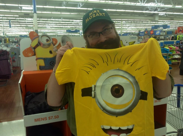 man wearing a yellow shirt with eyes on it