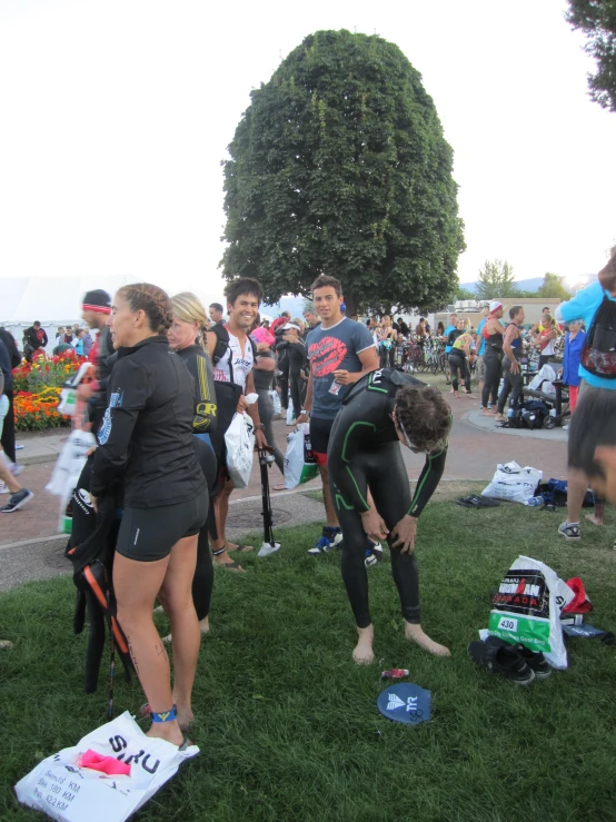 a bunch of people standing around getting ready to swim