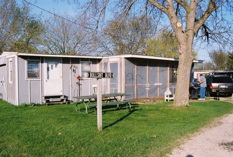 two portable homes are being set up for storage in a park