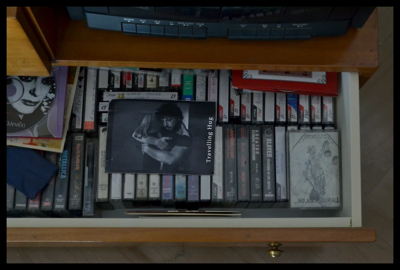 a book shelf filled with dvds, books and pictures