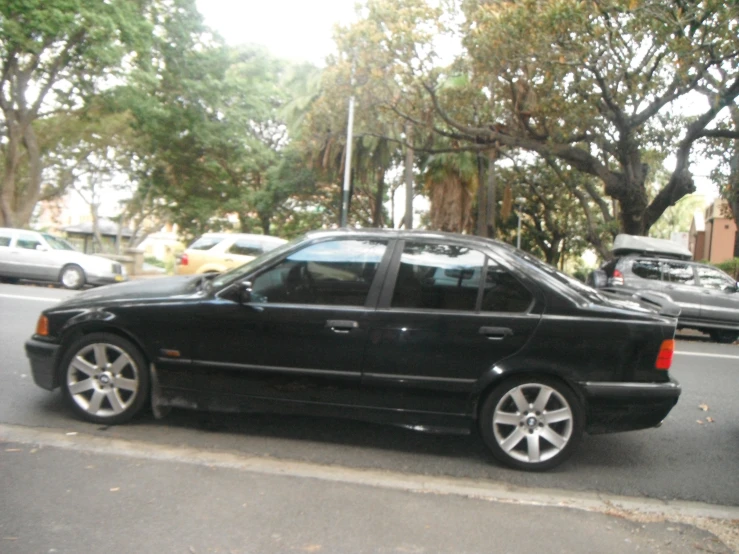 a black car parked in front of a street