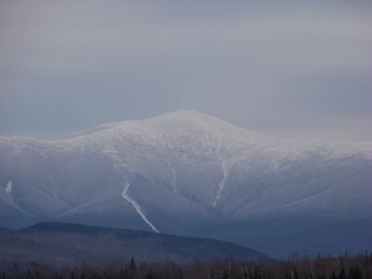 the ski slope on the hill has no trees