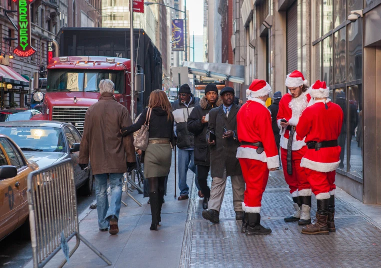 a bunch of people dressed in santa claus suits