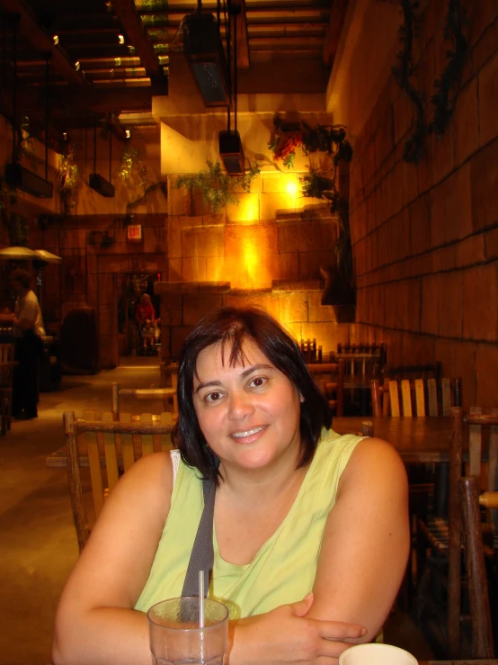 woman sitting at a table smiling at the camera