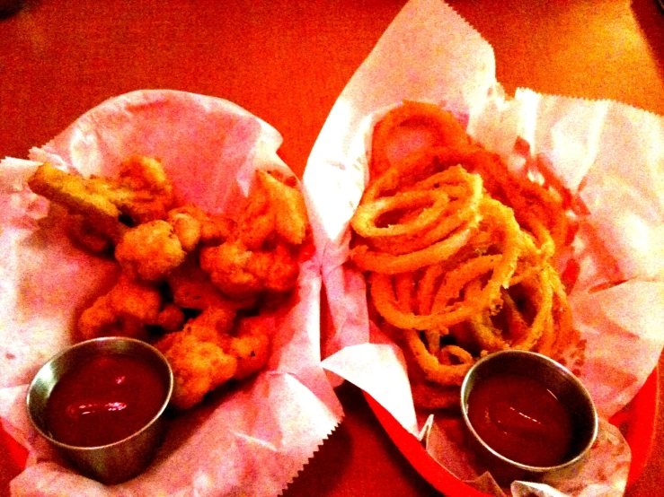 two baskets filled with food on top of a table