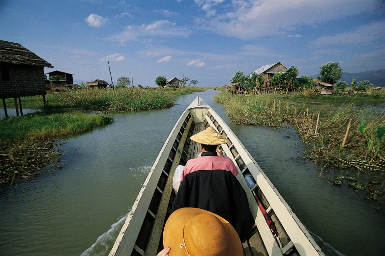 a man riding on the back of a boat through the water